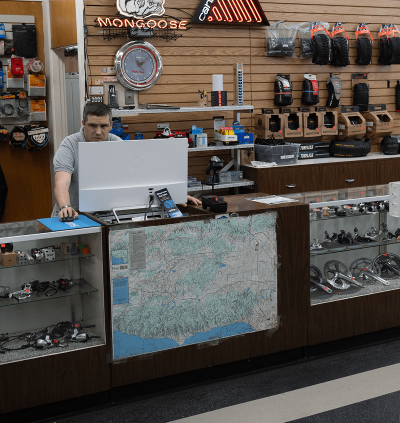 Man working at bicycle shop counter