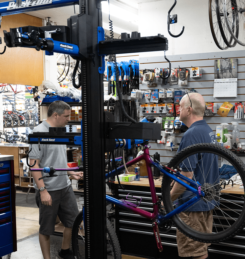 Bike maintenance in a busy repair shop.